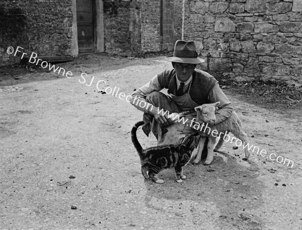 MAN BOTTLE FEEDING LAMB